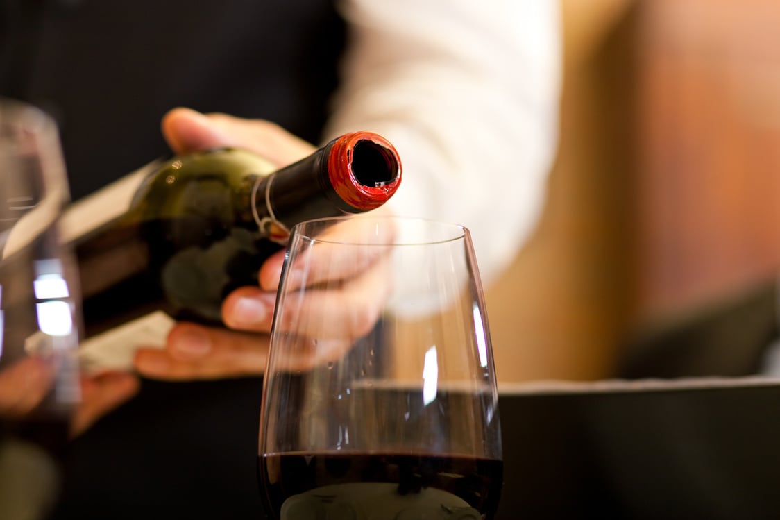 Waiter serving wine